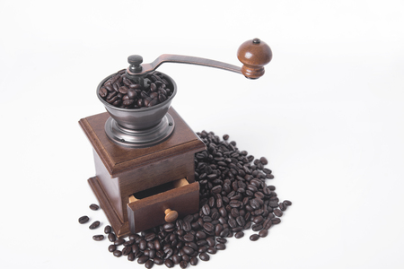 coffee grinder with arabica coffee beans on white background.の写真素材