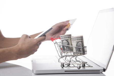 Shopping cart with dollar money on computer. concept shopping online.の写真素材