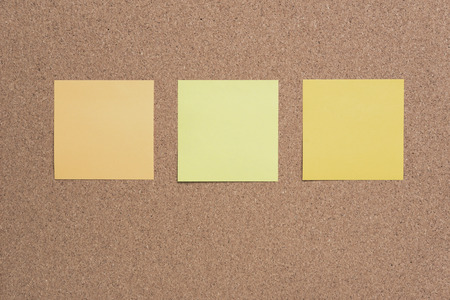 sticky note or post is on cork bulletin billboard.