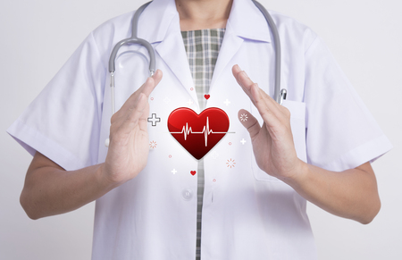 woman doctor with stethoscope holding heart icon. concept health insurance.の写真素材