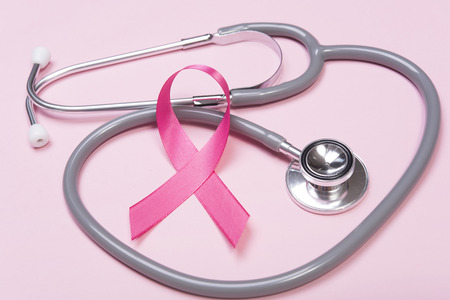 pink ribbon breast cancer and stethoscope on pink background. の写真素材