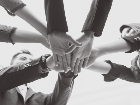 young people putting their hands together. concept teamwork and unity.
