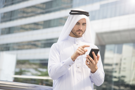 businessman arabic hand using mobile phone. concept communication.の写真素材