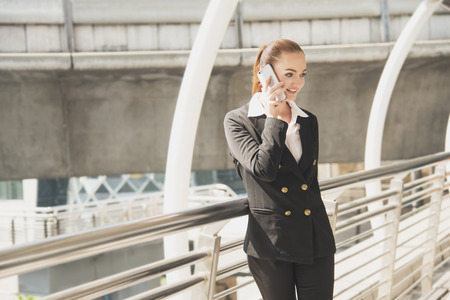 Handsome businesswoman talking on mobile phone.の写真素材