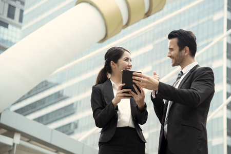 Businessman and businesswoman partner consulting and discussing at outdoor.の写真素材