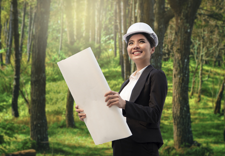Business eco engineer hand holding construction drawing. concept environment planning for engineering.の写真素材