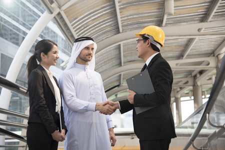 businessman arabic with engineer making handshake agreement. concept partner to business.の写真素材