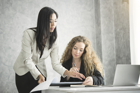 Manager and secretary consult for working in the office desk.の写真素材