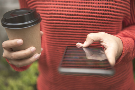 using mobile phone social media and coffee cup. の写真素材