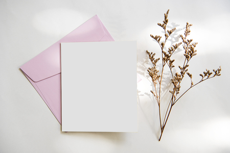 Blank white greeting card with envelope and flower. for mockup template. vintage tone.の写真素材