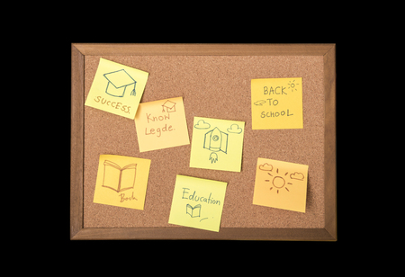 sticky note or post is on cork bulletin billboard isolated on black background..