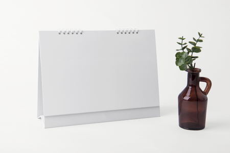 paper spiral calendar and vase for mockup template advertising and branding isolated background.の写真素材