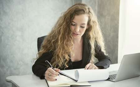 businesswoman sitting at desk and working for something in her office. concept leader corporate.の写真素材