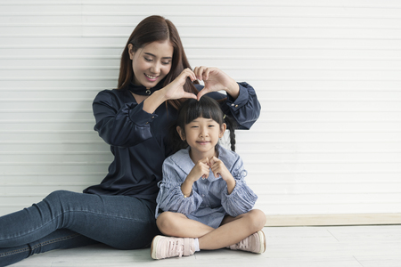 Asian mother and daughter hugging together in livingroom at home. concept Happy mother's day.の写真素材