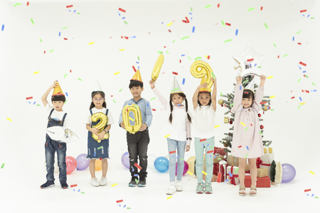 Group of kids celebrate christmas and happy new year 2019 party together.の写真素材