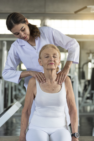 Physiotherapist helping old senior woman in physical center. elderly health lifestyle concept.の写真素材