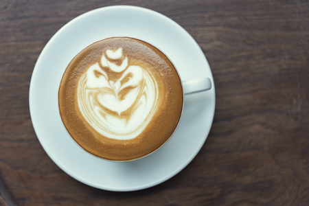 latte or Cappuccino with frothy foam, coffee cup top view on table in cafe.の写真素材