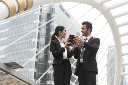 Businessman and businesswoman partner consulting and discussing at outdoor.の写真素材