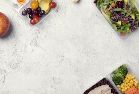 Fresh healthy diet lunch box with vegetable salad on table background with free text space for diet menu.の写真素材