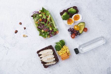 Fresh healthy diet lunch box with vegetable salad on table background with free text space for diet menu.の写真素材