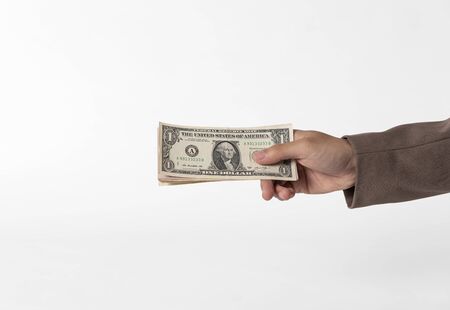 Hand holding money isolated on white background.の写真素材
