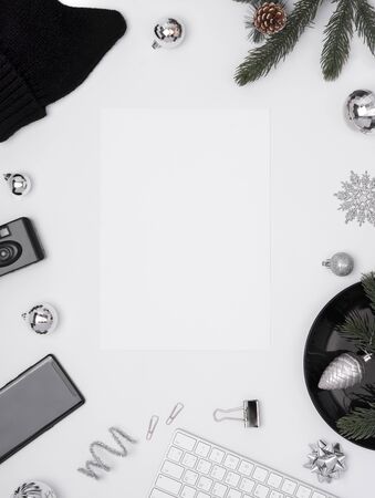 Top view of white desk with mockup paper calendar for January and decorative stuff. christmas and happy new year.の写真素材