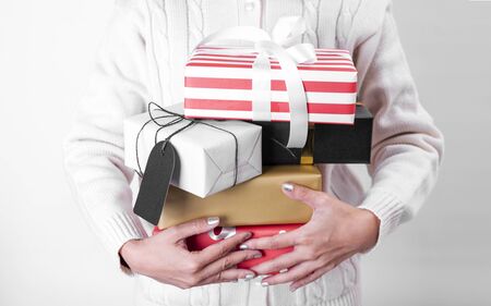 women hand holding gift box and paper tag isolated on white background for christmas and new year concept.の写真素材