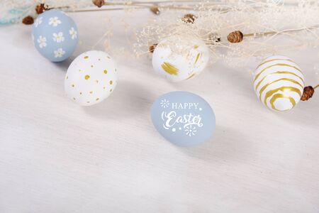 Happy easter handmade eggs colored painted with flower  on wooden table.