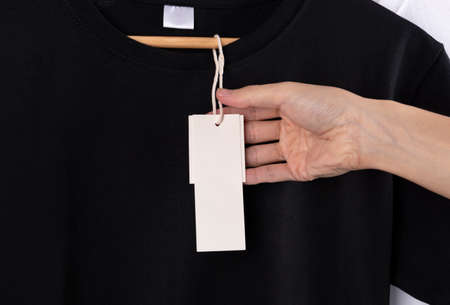Mockup blank black t-shirt and blank label tag for advertising.の写真素材
