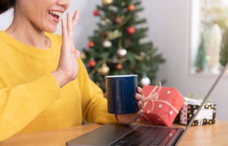 Virtual Christmas day office party. business woman smiling celebration having video conferencing via...