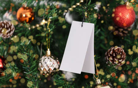 mockup christmas greeting tags on christmas tree background.の写真素材