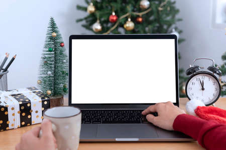 Mock up laptop computer with white screen on office table.  Home office desk workspace. Mock up copy...