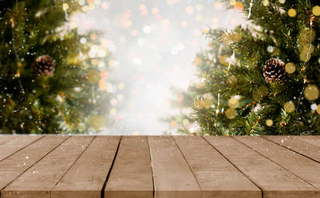 empty christmas table background with christmas tree out of focus for product display montage.