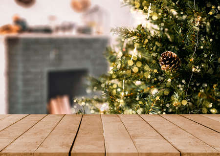 empty christmas table background with christmas tree out of focus for product display montage.の写真素材