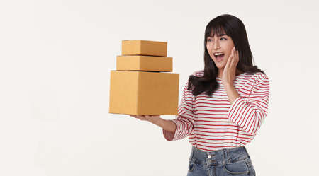 Shocked Asian woman holding package parcel box. Special delivery courier and shipping service...