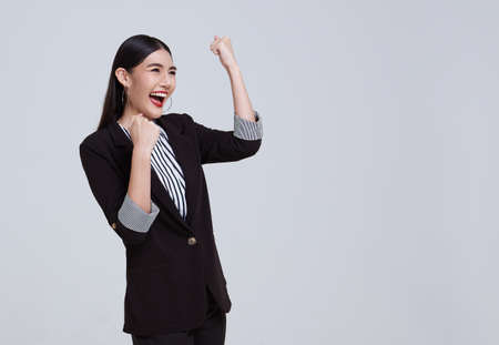 portrait of young Asian businesswoman happy and success isolated on studio white background.の写真素材