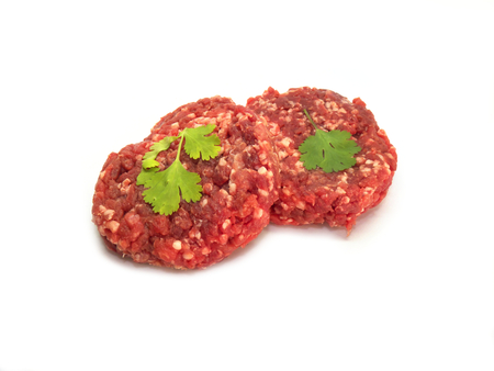 Beef burgers with parsley isolated on a white backgroundの写真素材