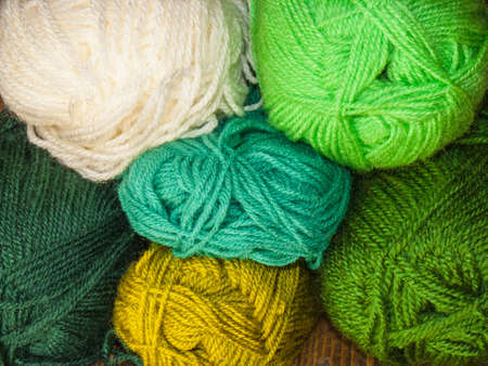 Skeins of colored wool, wall of wool in green tonesの写真素材