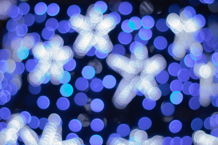 Blue shine with bokeh effect and selective focus. Festive background with bright blue lights, blue starsの写真素材