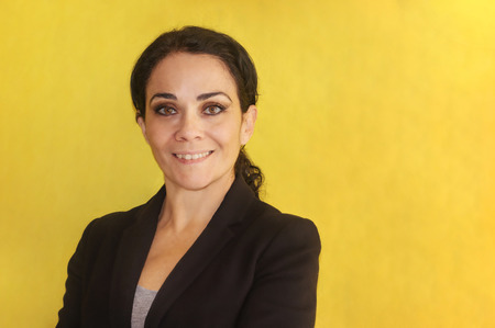 Beautiful brunette business woman over isolated background smiling looking to the camera convinced...