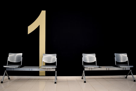 Empty hospital waiting room number one with metal chairsの写真素材