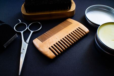 Materials for a perfect beard. Scissor, shaver, comb, wax and brush, all made with natural materialsの写真素材