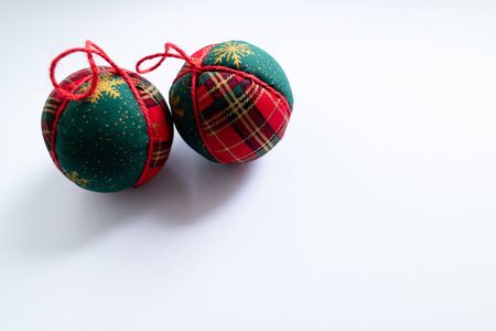 Christmas balls with traditional red and green winter print on white background. Isolated and top view.の写真素材