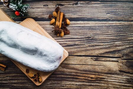 Christmas stollen bread with cinnamon, raisins and anise on wooden table. Top viewの写真素材