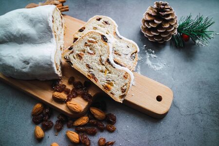 Christmas stollen cake with cinnamon, anise, ginger, almonds and raisins on concrete background. Close up view.の写真素材