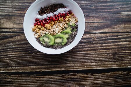 Smoothie bowl with organic ingredients on wooden table. Copy space Top viewの写真素材