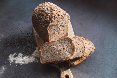 Millet and buckwheat bread slices on wooden table.
