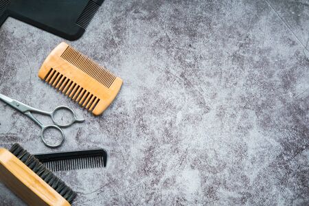 Beard kit with scissors, brush and combs isolated on concrete background. Grooming a perfect beard. Flat lay. Top view. Copy space.の写真素材