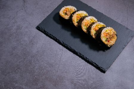 Korean sushi roll Kimbap with jeyouk pork and vegetables. Traditional cuisine