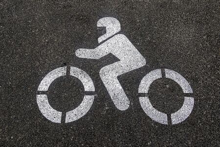 Signaling to park the motorcycles painted with white paint on the pavement in the streetの写真素材